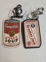 Both Coach bag charms showing full designs and hardware