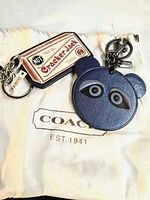 Both charms and dust bag overview