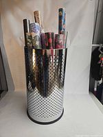 Full view of perforated stainless steel holder with paper rolls