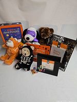 Group shot showing all plush toys, frames, tin, small magnet