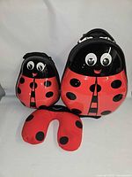 Suitcase, backpack and neck pillow front view