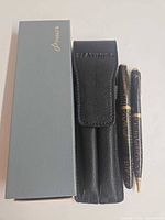Set displayed with grey Parker box, black leather pouch and both writing instruments