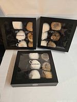 Three Rudsak boxed sets of fur pom-poms