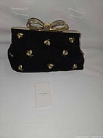 Front view of velvet clutch showing bee embroidery and overall condition