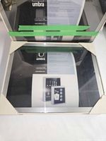 Two boxed Umbra Pandora frames showing front graphics through plastic