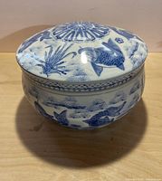 Covered porcelain bowl with lid in place showing exterior decoration