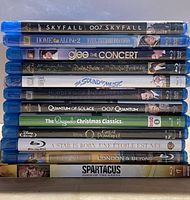 Stack of 13 Blu-ray cases showing spines with movie titles