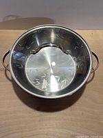 Top view showing interior etched design and side handles of pot