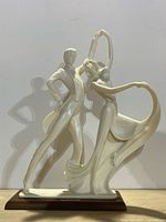 Full front view of Santini dancing couple statue