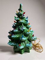 Full view of ceramic Christmas tree showing base, cord, and lights