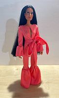 Full view of Cher doll in coral jumpsuit