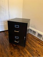 Front view of black 2-drawer metal filing cabinet