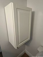 Closed view of the white wall cabinet