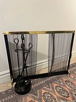 Fireplace screen with tool set positioned in front