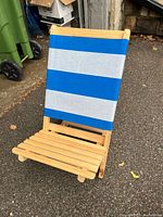 Full view of assembled chair standing, showing wood base and striped canvas backrest