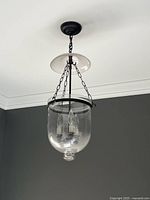 Large glass pendant light hanging from ceiling