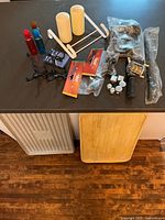 overview of lot items on countertop and two boot trays