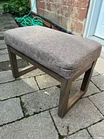 Full view of upholstered ottoman bench on patio