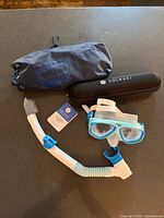 Solbari umbrella case, Speedo mask and snorkel, folded umbrella, backrest bag