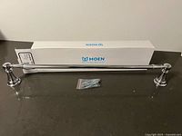 Towel bar assembled with box and mounting screws