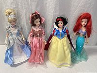 Group shot of four Disney Princess dolls standing side by side