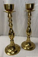Full view of both brass candlestick holders