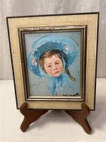 Full view of framed print on stand