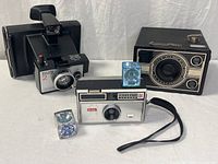 All three cameras and flashcubes grouped together