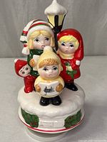Front view of ceramic music box with four carolers and lamppost