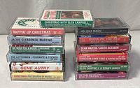 All 13 Christmas cassette tapes stacked in two columns with one across the top