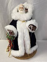 Full front view of Santa Claus figurine on wooden base
