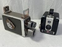 Front view of both Kodak Brownie cameras showing lenses, faceplates, and branding