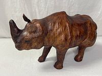 Full left-side view of leather rhinoceros figurine