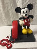 Full telephone front view showing Mickey figure, handset, base and cord