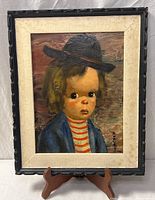 Full view of framed painting on stand