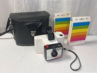 Camera, case and two film packs full view