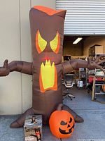 Full view of inflated evil tree with pumpkin and box