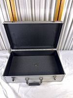 Open aluminum case showing interior foam lining