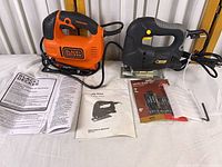 Both jigsaws, blade pack, loose blades and manuals displayed