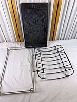 Full view of cast-iron grill plate, wire rack and stainless frame
