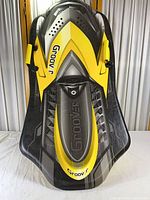 Front view of yellow and black Groover sled showing full shape and graphics