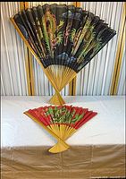 Both folding wall fans fully opened showing size, colours and design