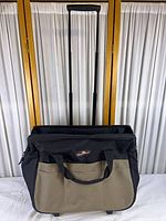 Front view of rolling tool bag with handle extended