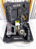 Open carry case showing RotoZip tool, attachment, blade, wrenches