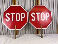 Both stop signs front view with handles visible