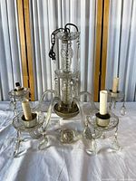 Full view of chandelier showing four arms, center column, sockets, prisms and loose crystal ball