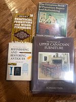 Four books including Practical Furniture and Wood Finishing, The Complete Book of Furniture Repair and Refinishing, The Homeowner's Guide to Refinishing and Restoring Antiques, The Heritage of Upper Canadian Furniture