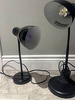 Both black desk lamps side by side showing size difference and cords