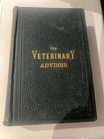 Front cover of The Farmers' Veterinary Adviser, dark green embossed cloth with gilt title