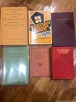 Front covers of all six bibliography and history books displayed